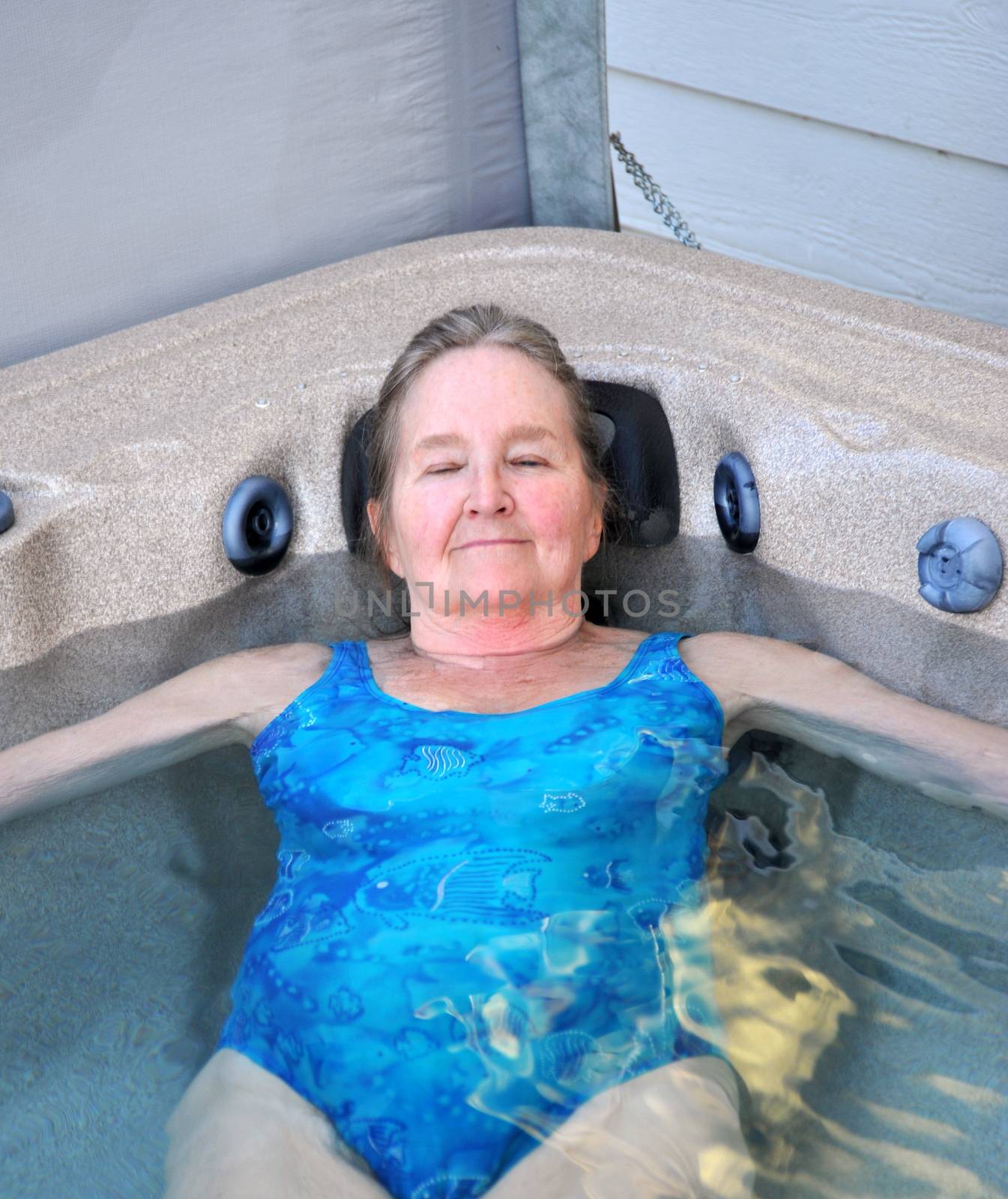 Mature female beauty enjoying her hot tub.