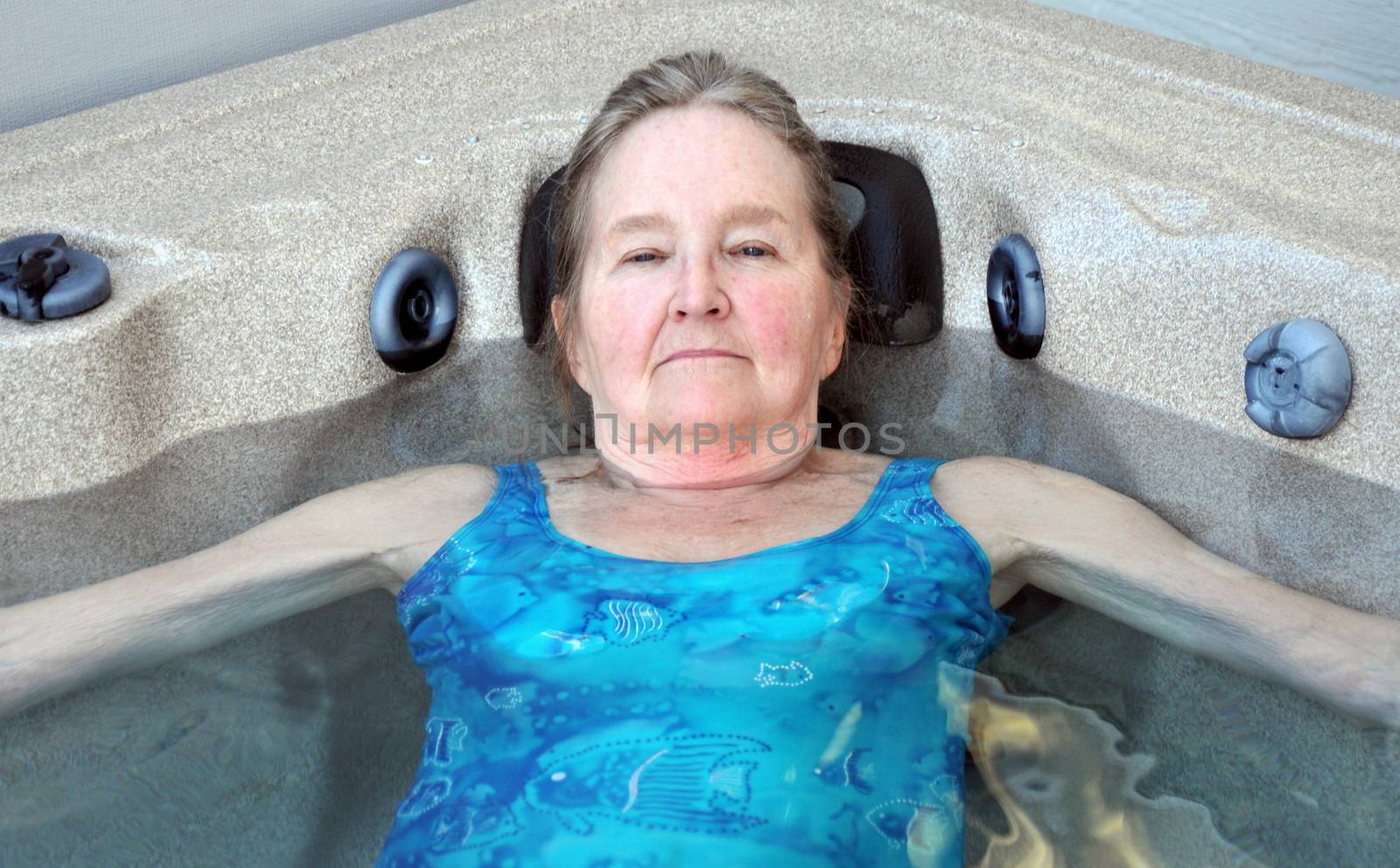 Mature female beauty enjoying her hot tub.