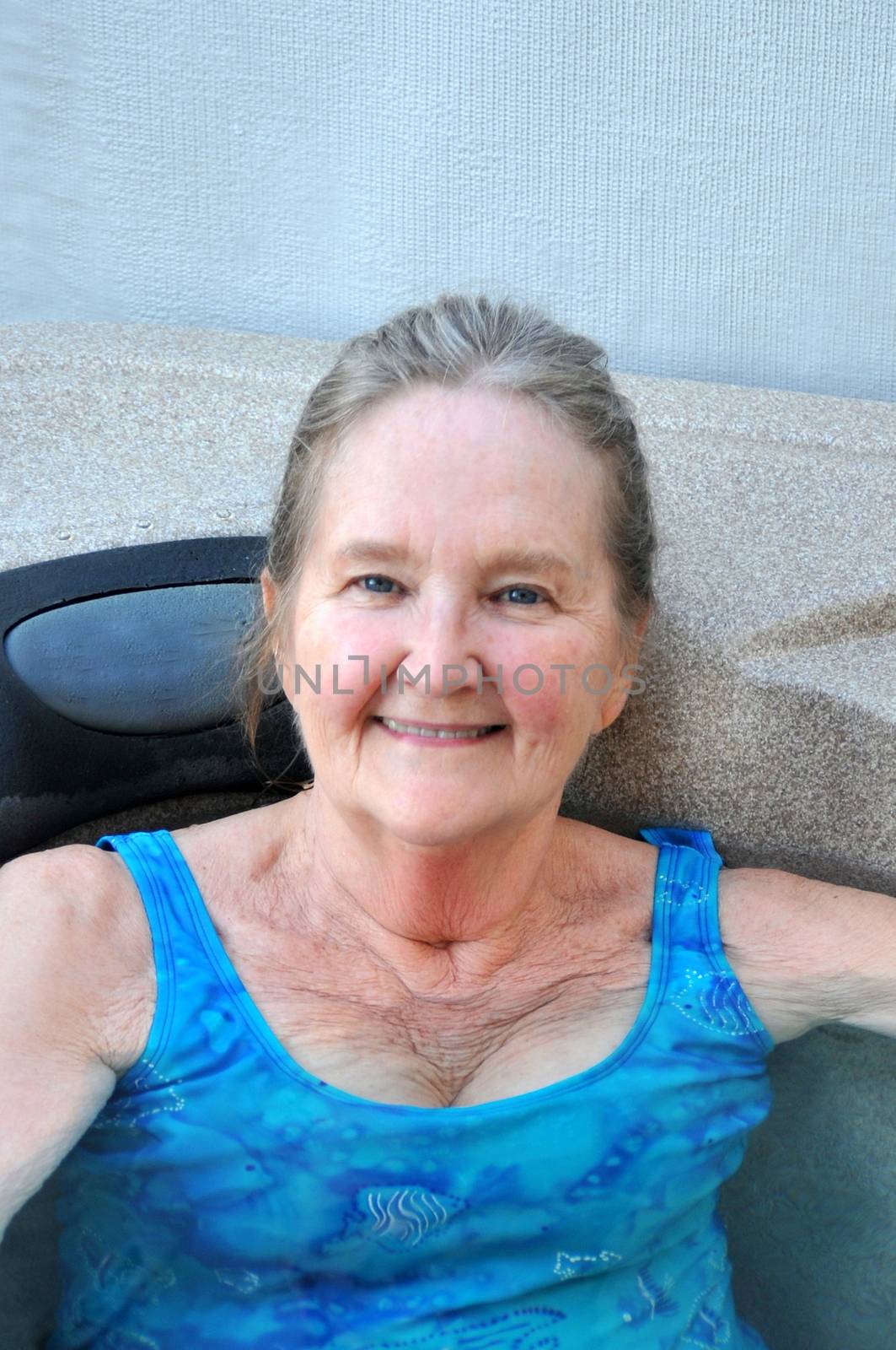 Mature female beauty enjoying her hot tub.