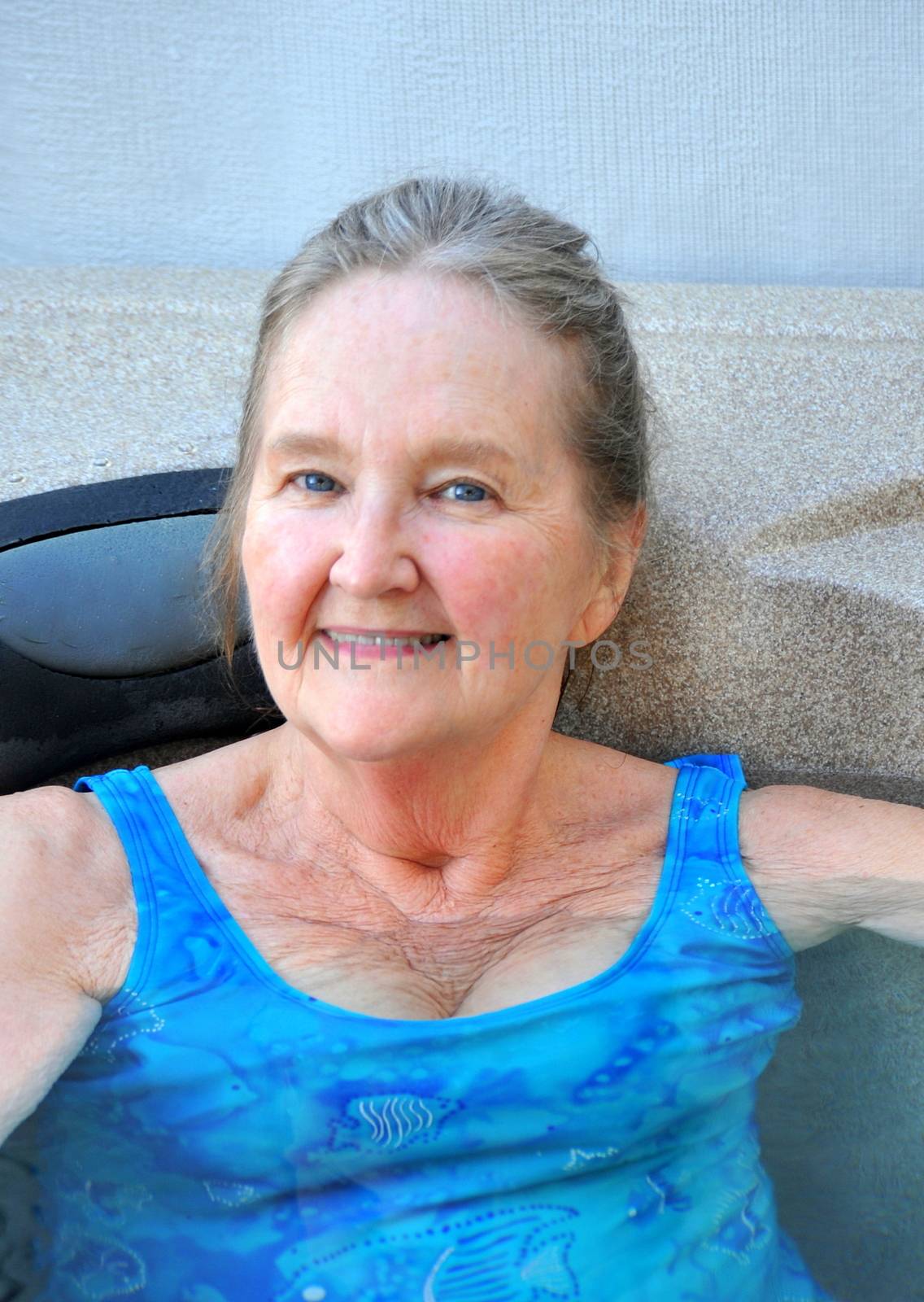 Mature female beauty enjoying her hot tub.