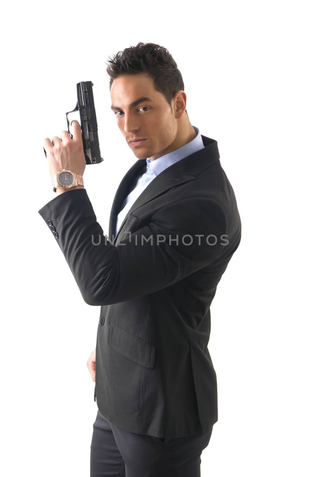 Elegant man with gun, dressed as a spy or secret agent, with earphones, isolated on white