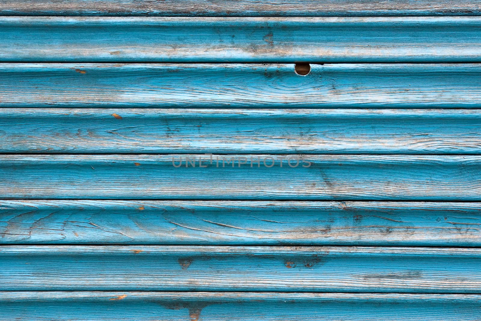 Dirty, stained by a paint the hammered together fence