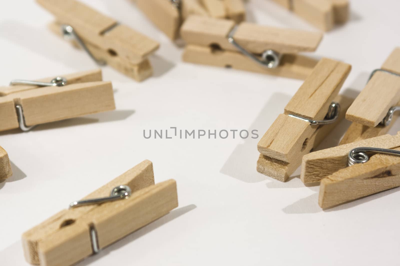 Wooden clothes pegs scattered on a table