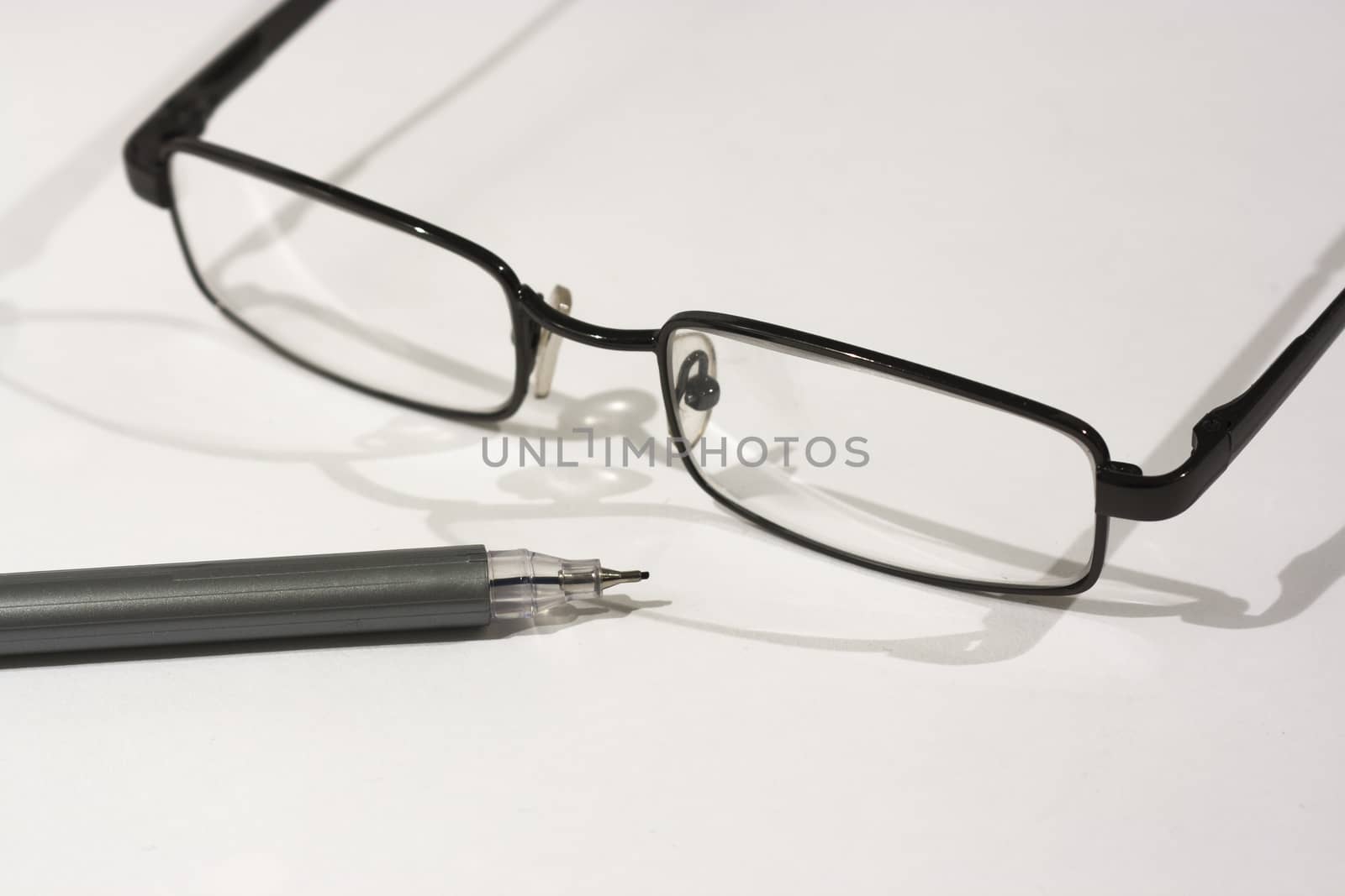 Close up of reading glasses on a white background