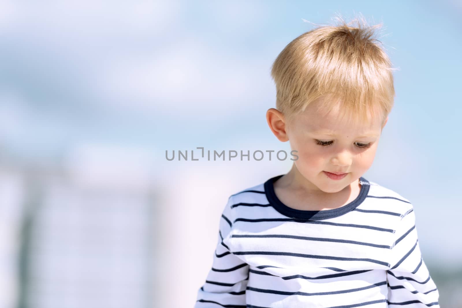 Portrait of little preschool boy outdoors copy space by Nanisimova