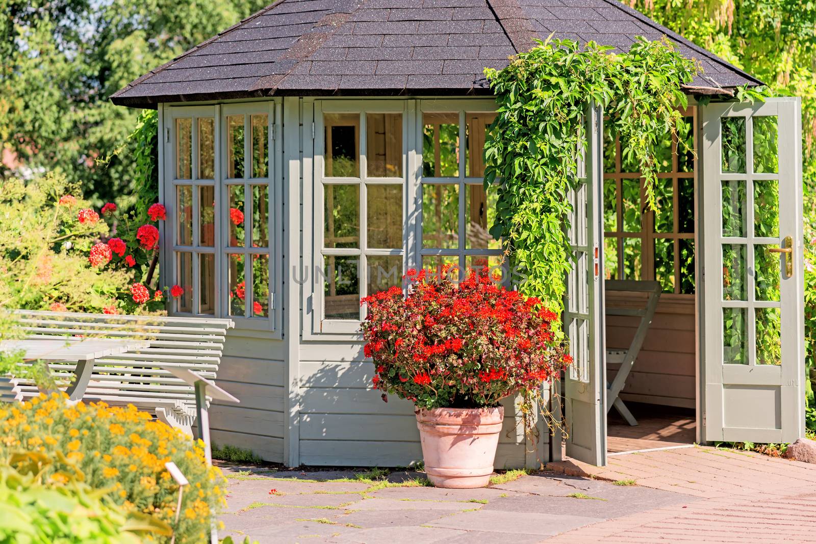 Outdoor wooden gazebo at sunset on summer