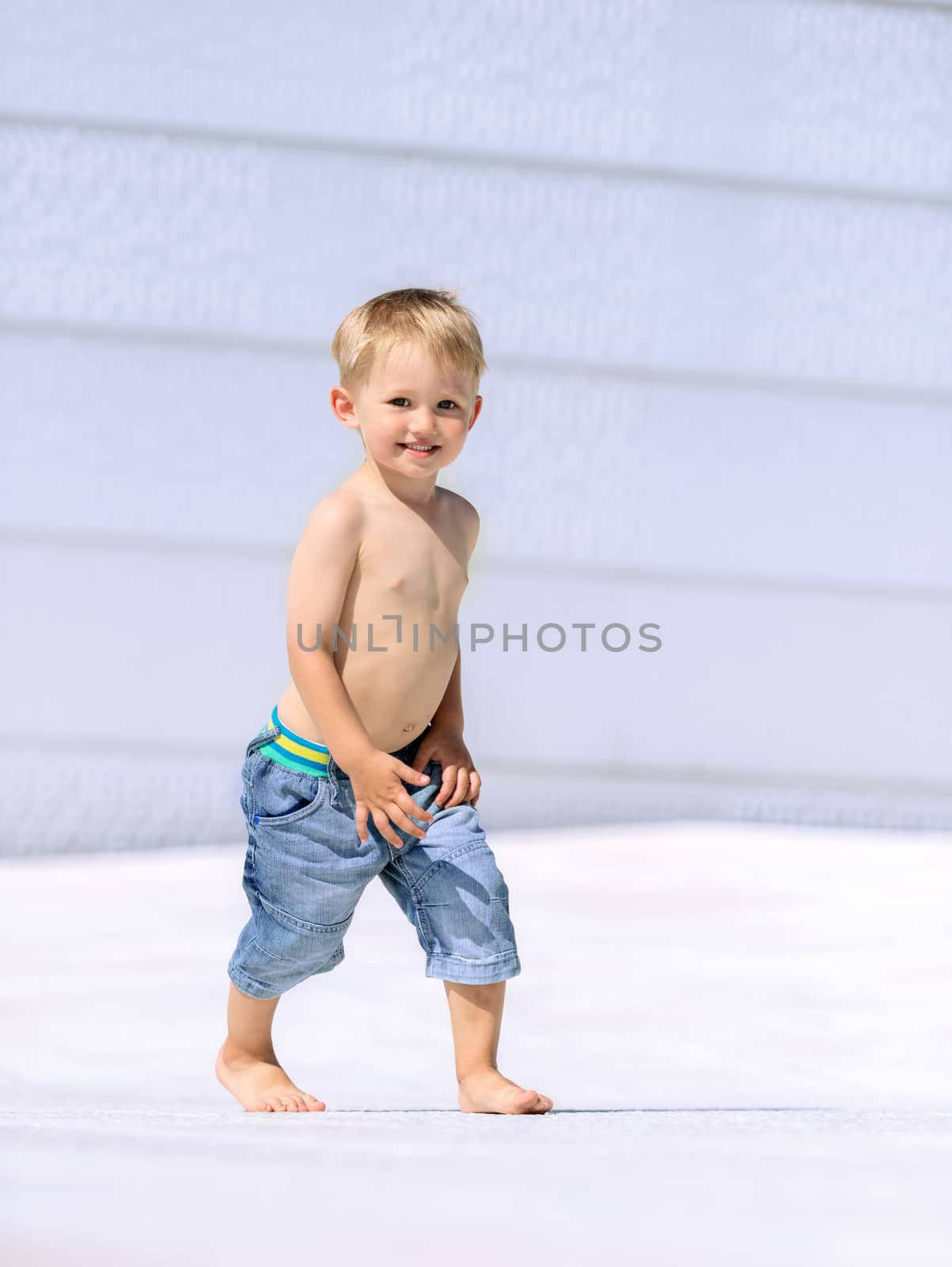 Portrait of little preschool boy outdoors walking by Nanisimova