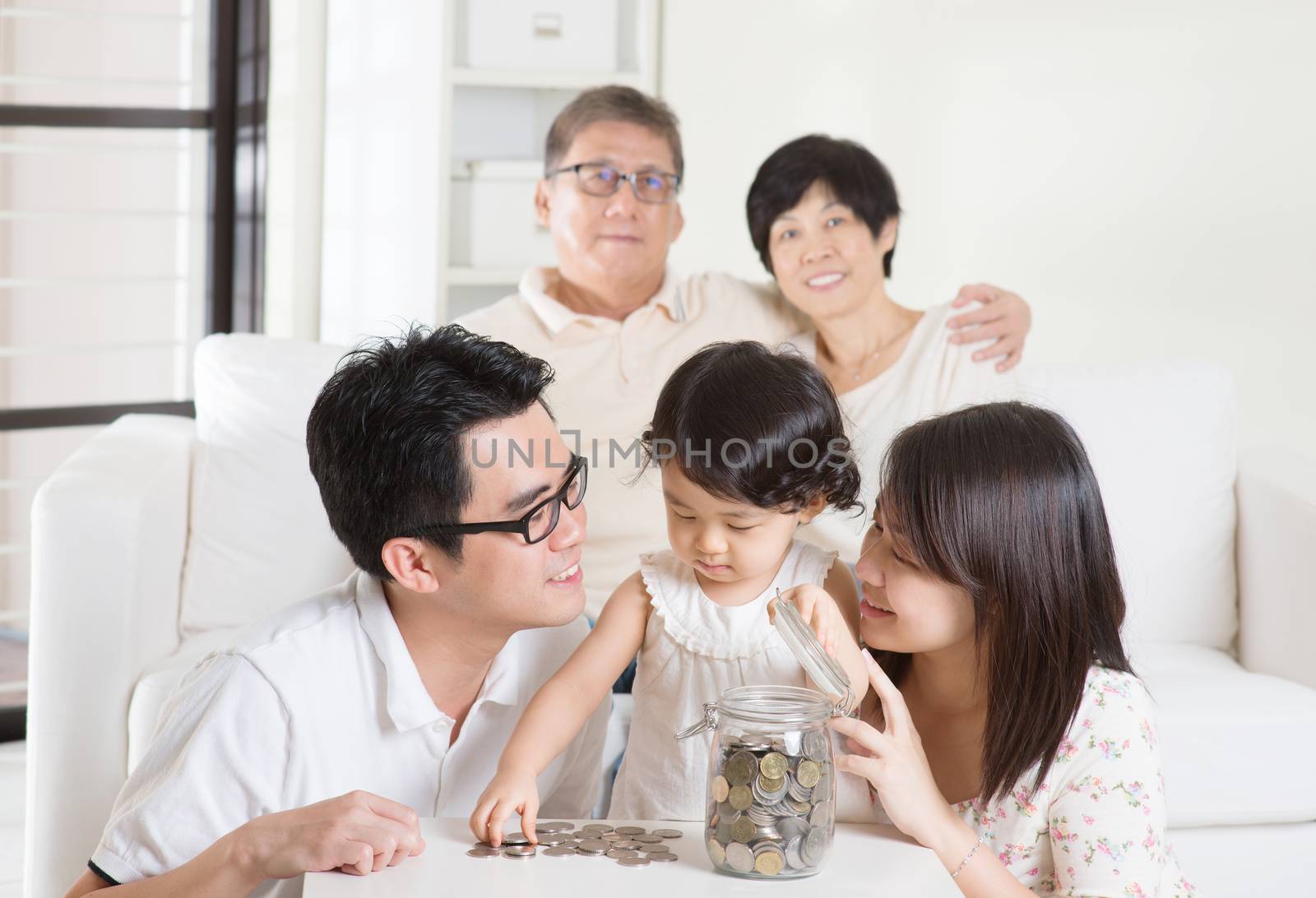 Asian family money savings concept. Multi generations living lifestyle at home.
