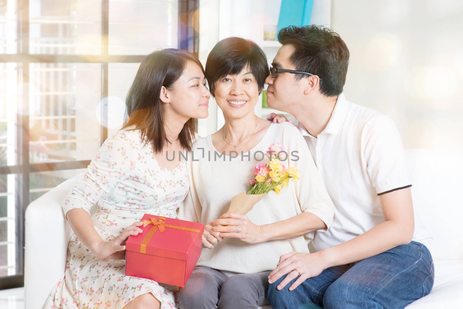 Happy mothers day. Asian boy and girl kissing mother. Family living lifestyle at home.