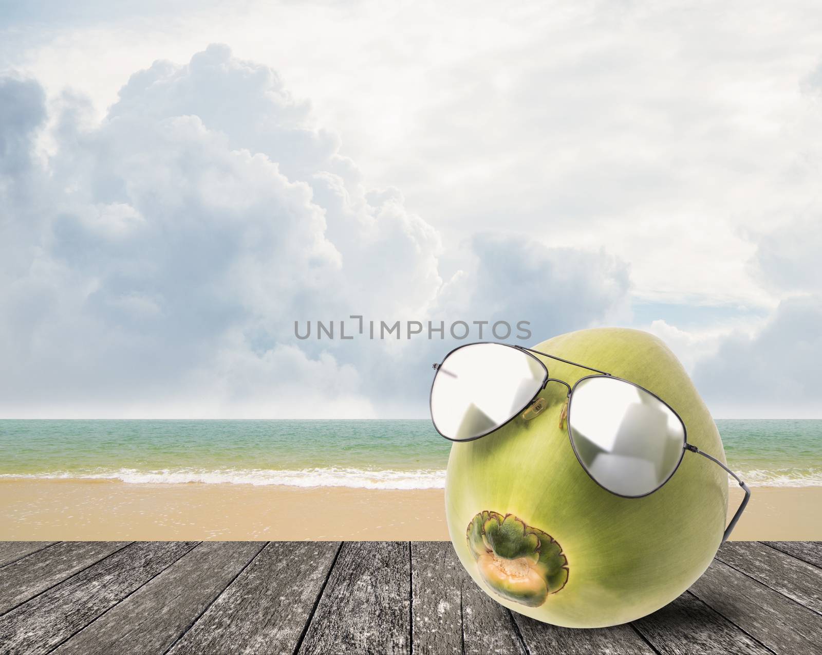 Coconut wear sunglasses beside beach, Summer concept