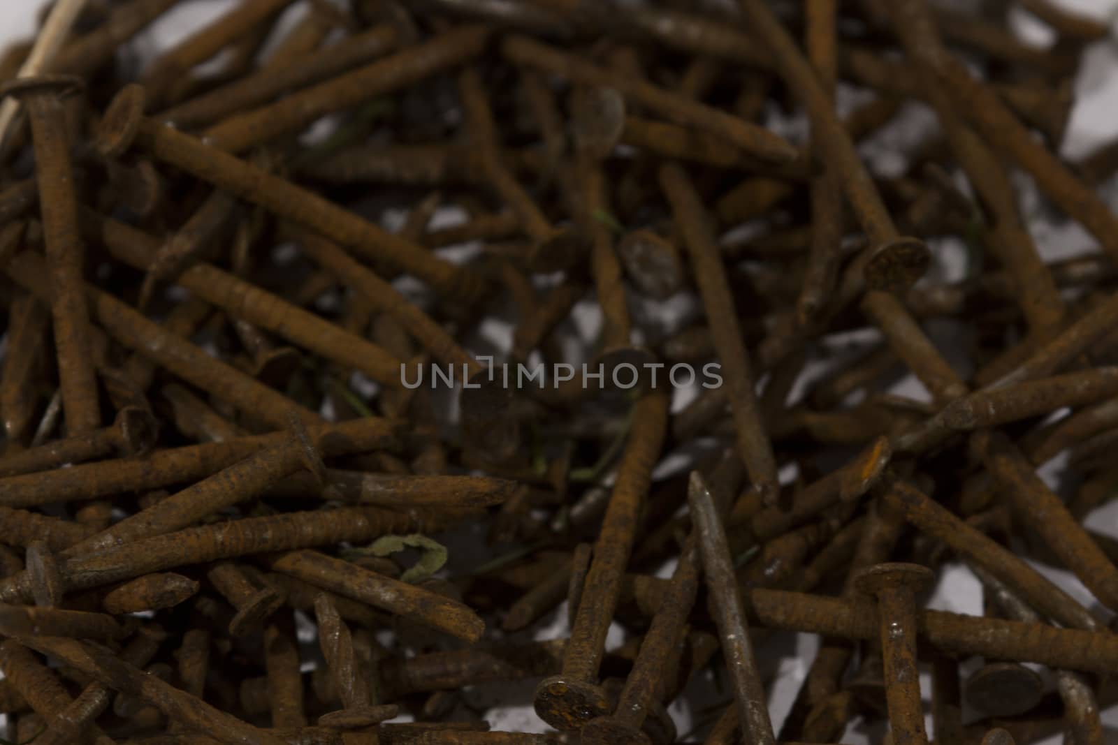 A pile of rusty nails spread out on a table