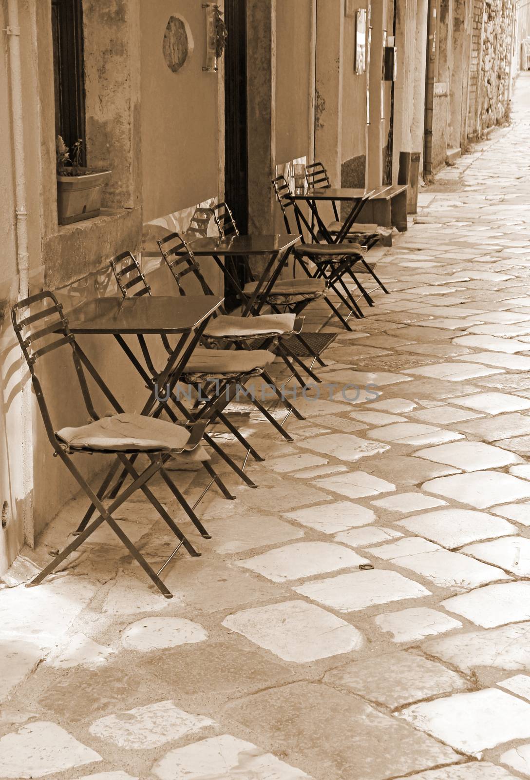 Greece. Corfu (Kerkyra) island. Corfu town. An open-air cafe. In Sepia toned. Retro style  