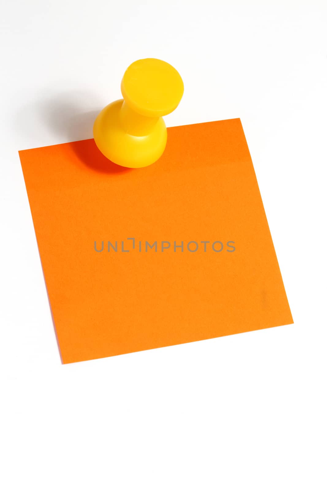 Orange reminder note with yellow big  pin.