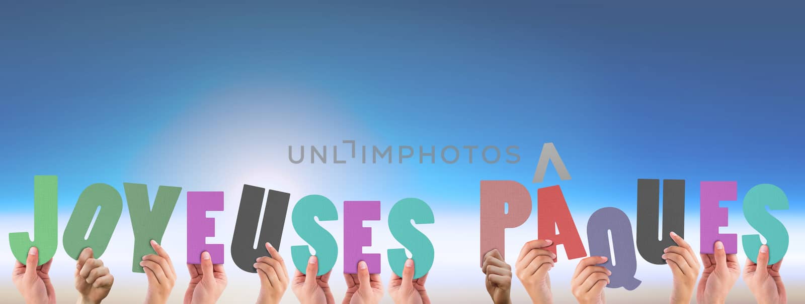 Composite image of hands holding up joyeuses pasques by Wavebreakmedia