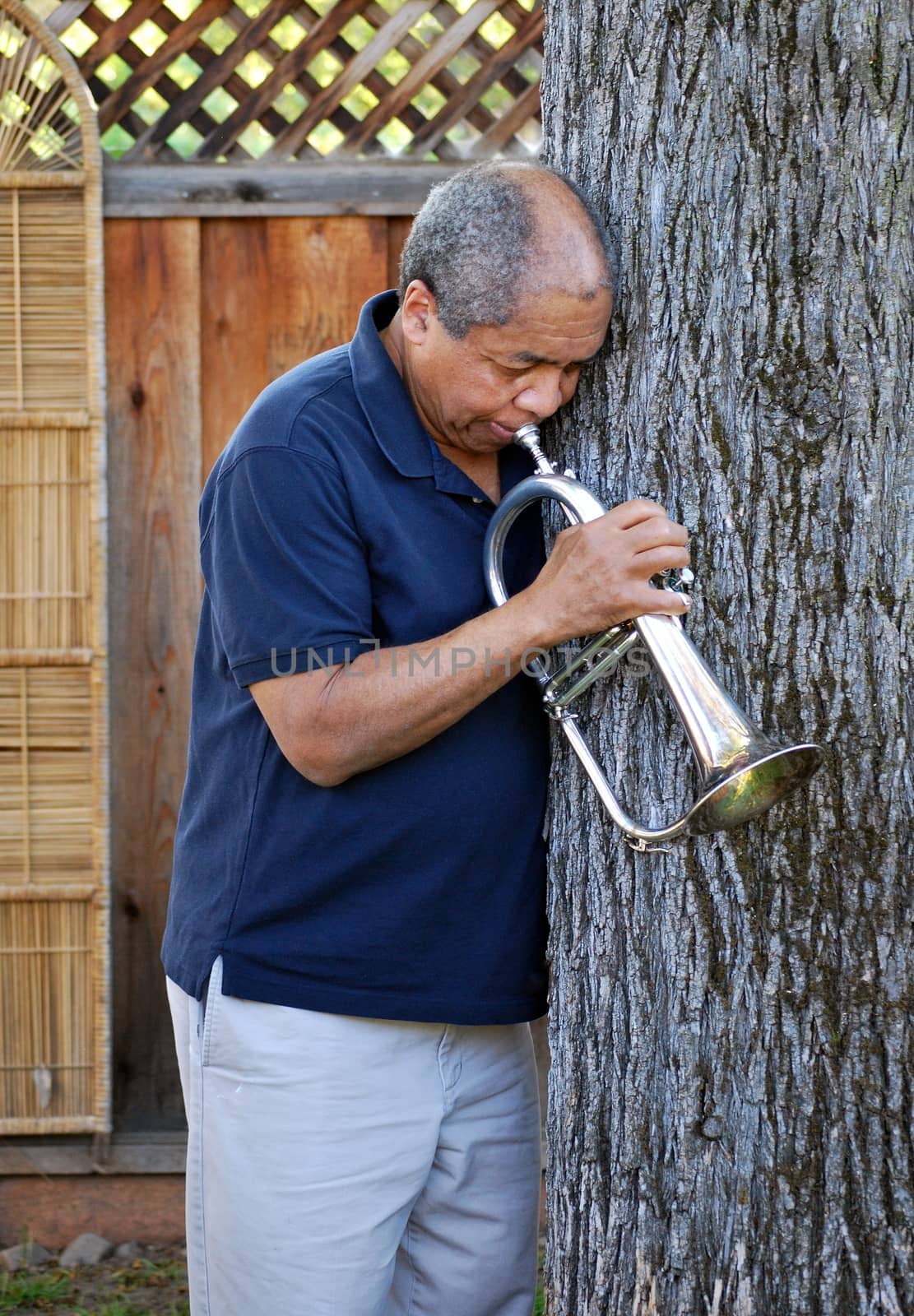 African american jazz musician with his flugelhorn outside.