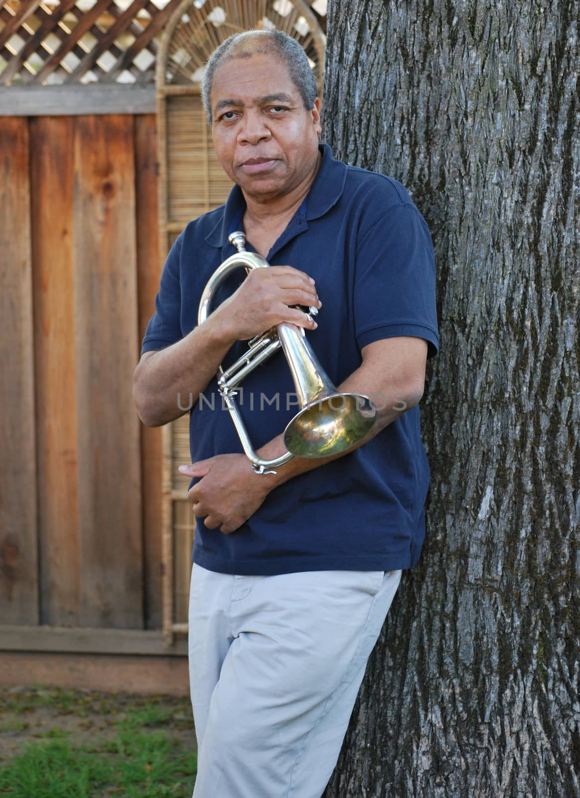 African american jazz musician with his flugelhorn outside.