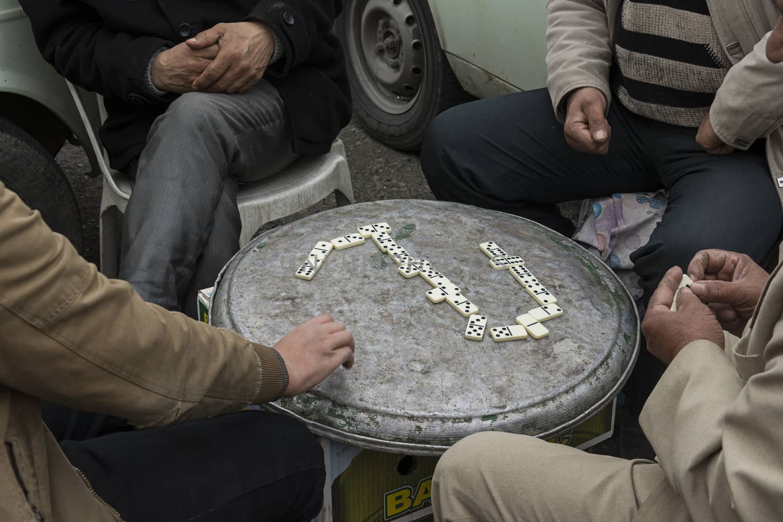 Group of men playing domino on free time.