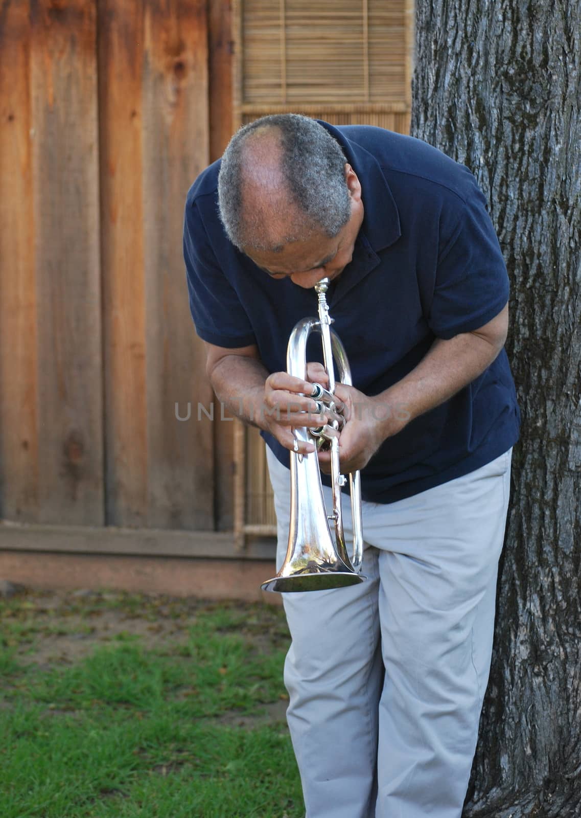 African american jazz musician with his flugelhorn outside.