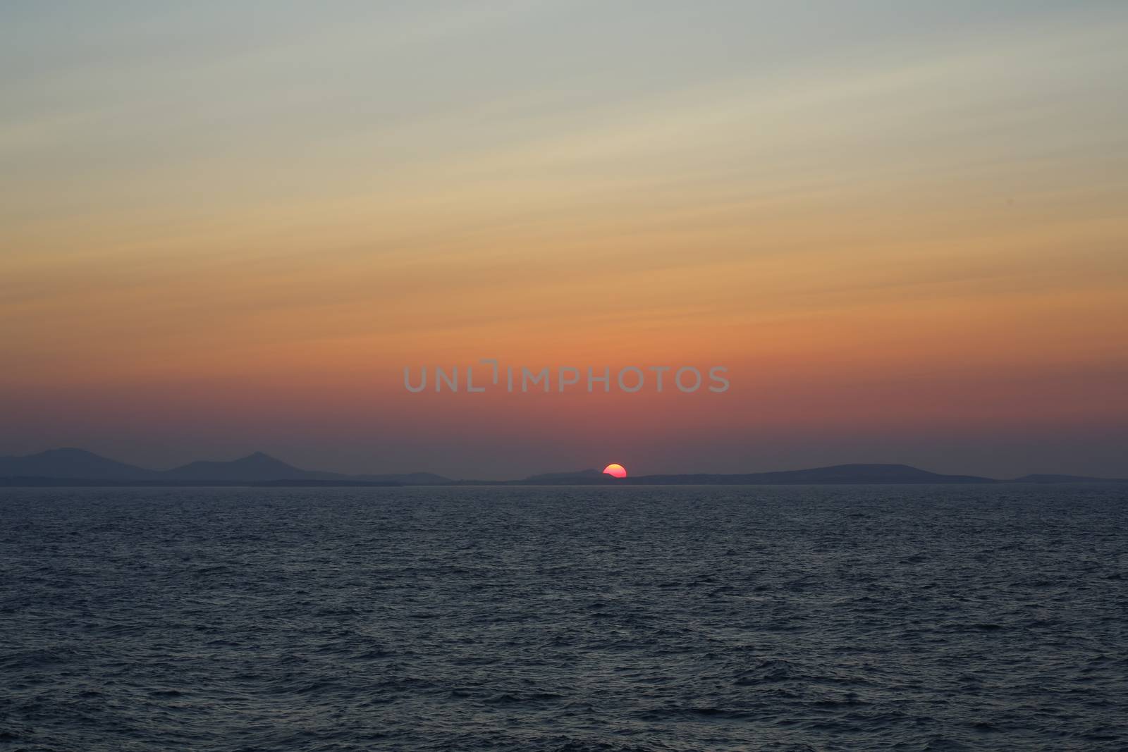 Sunset at the Portara Gate of the Apollo Temple in Naxos island