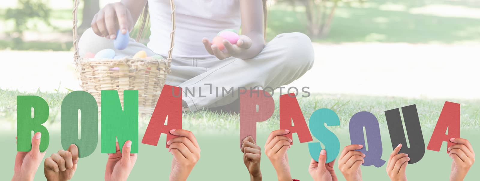 Hands holding up bona pasqua against little girl sitting on grass counting easter eggs smiling at camera