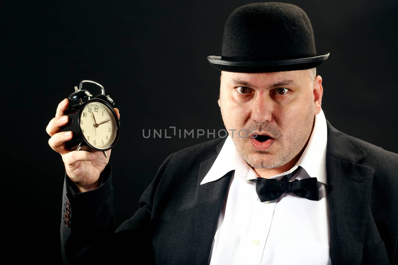 A Businessman holding alarm clock. Time for work concept