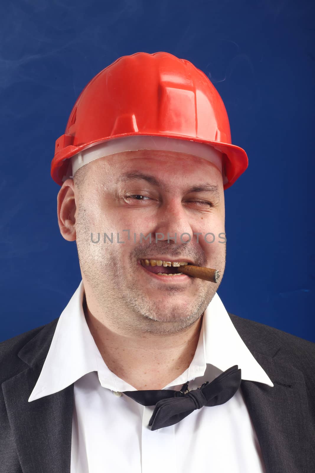 Portrait of man with red helmet and cigar 