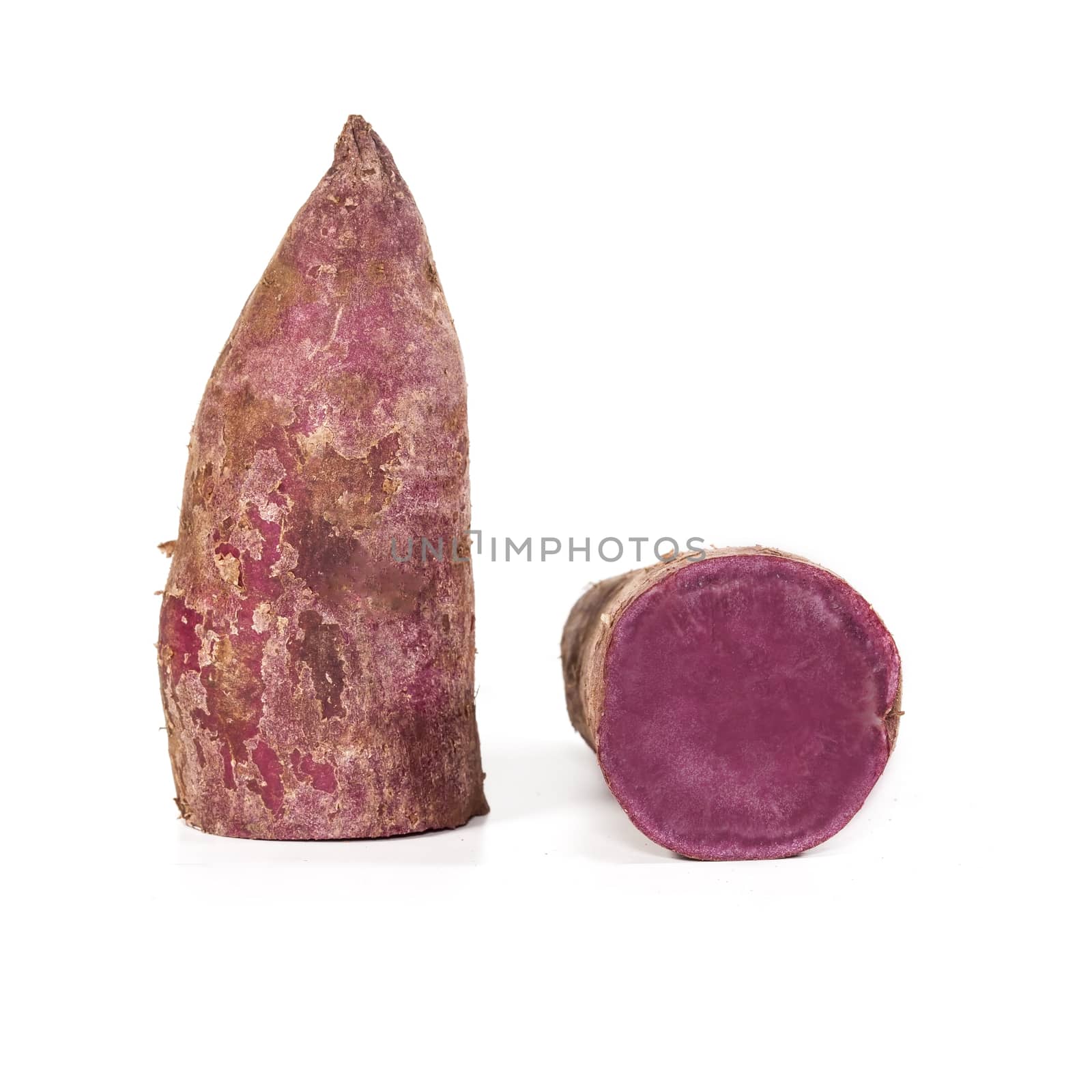 Whole purple yams on a white background