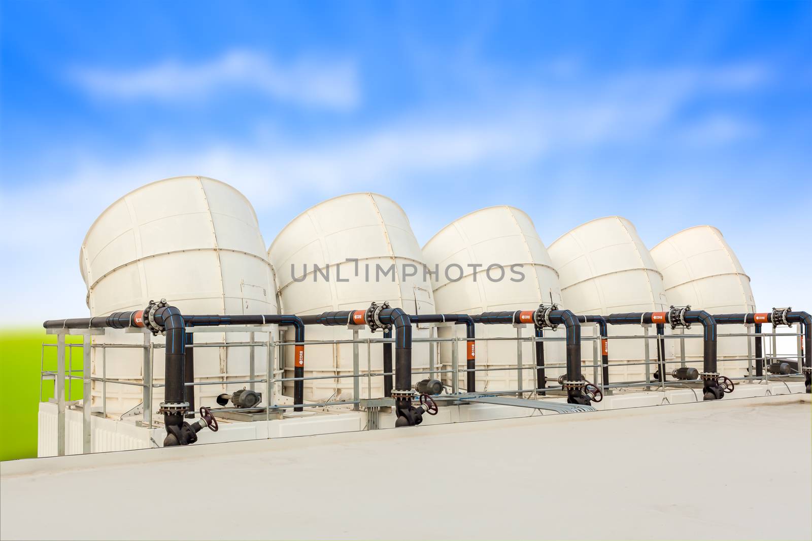 ventilation pipes of industrial building roof top and blue cloud sky background