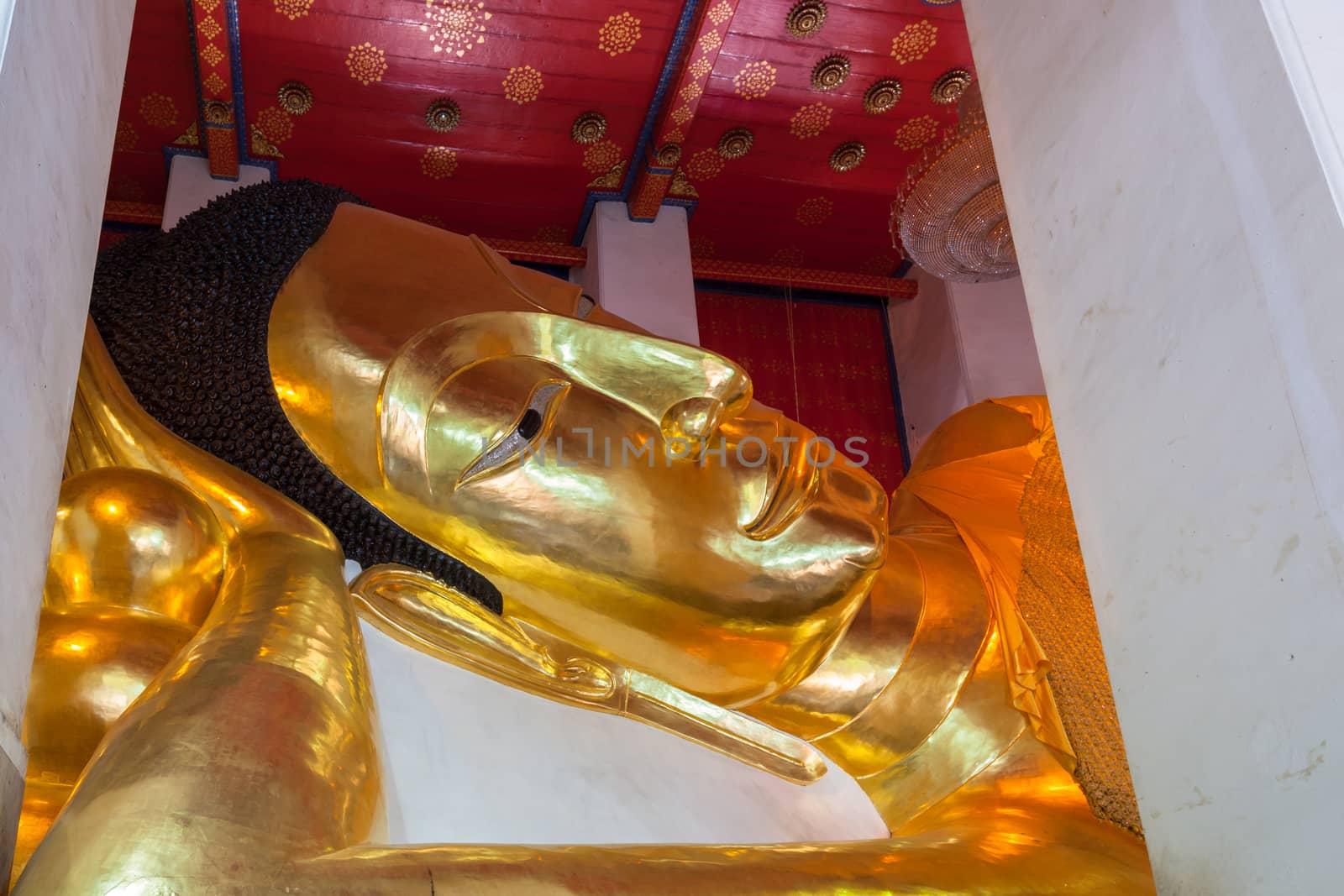 Golden Buddha statue, the largest reclining Buddha image in temple names "Wat Phra Non Chakkrasi Worawihan" at Singburi, Thailand can use religious concept background