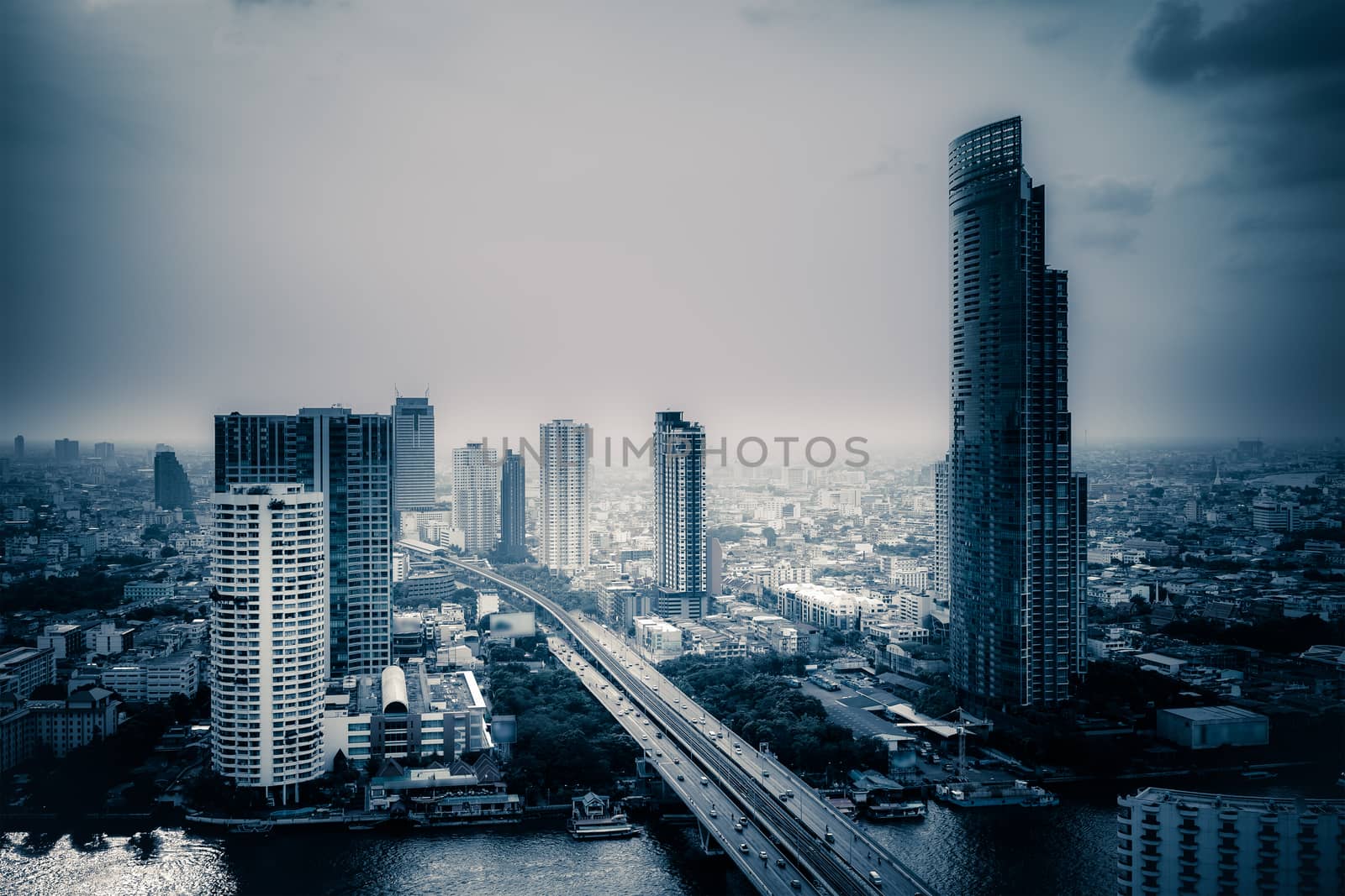 Business Building Bangkok city area at twilight scene with transportation car and ship as panorama, high angle bird eyes view