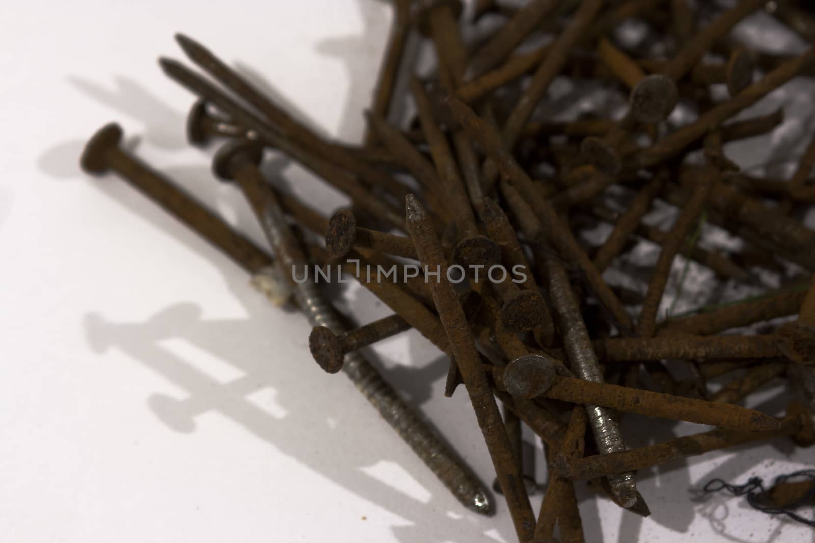 A pile of rusty nails spread out on a table