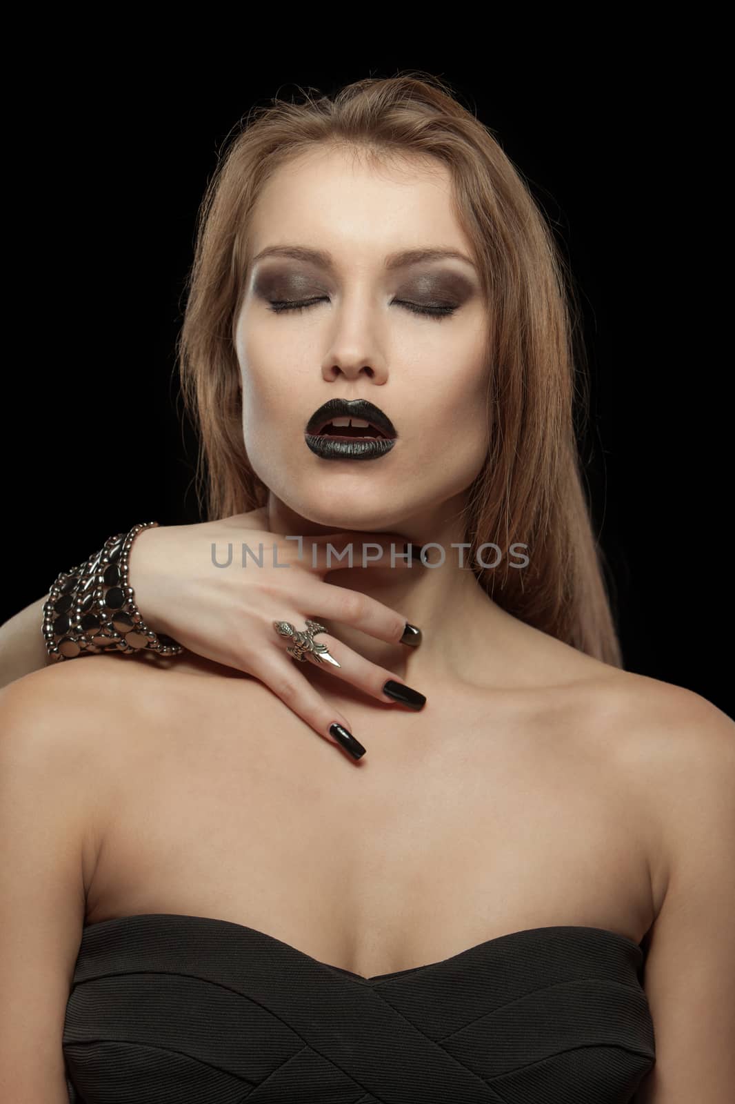 Gothic woman close your eyes with hand of vampire on her neck on black background