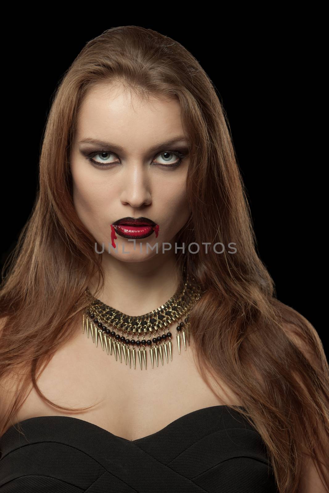 Portrait of a pale gothic vampire woman on a black background