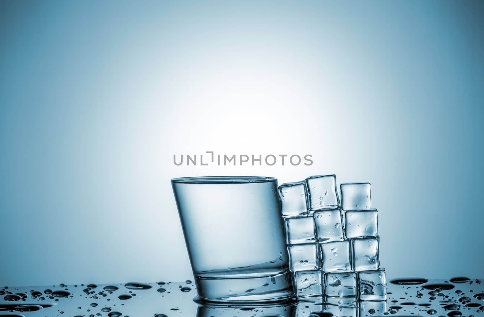 Water in glass and ice cubes, lying next by master1305