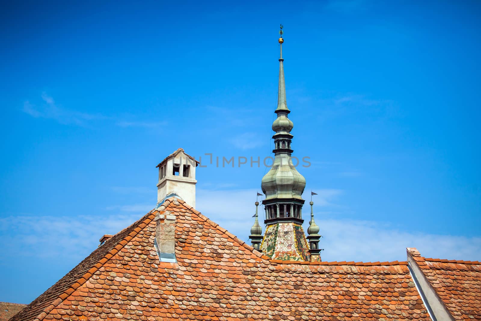Sighisoara, Romania - June 23, 2013: Clock Tower typical roof and chemnee from Sighisoara fortress, Transylvania, Romania