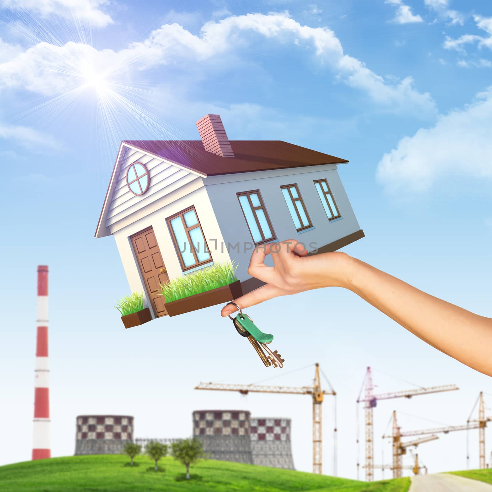 House on businesswomans hand on nature background with building crane, NPP