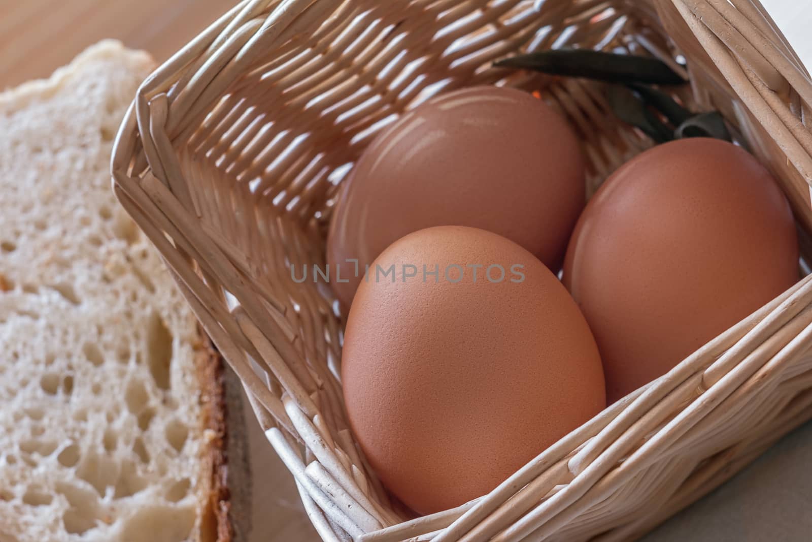 photograph depicting eggs in the basket and sliced bread
