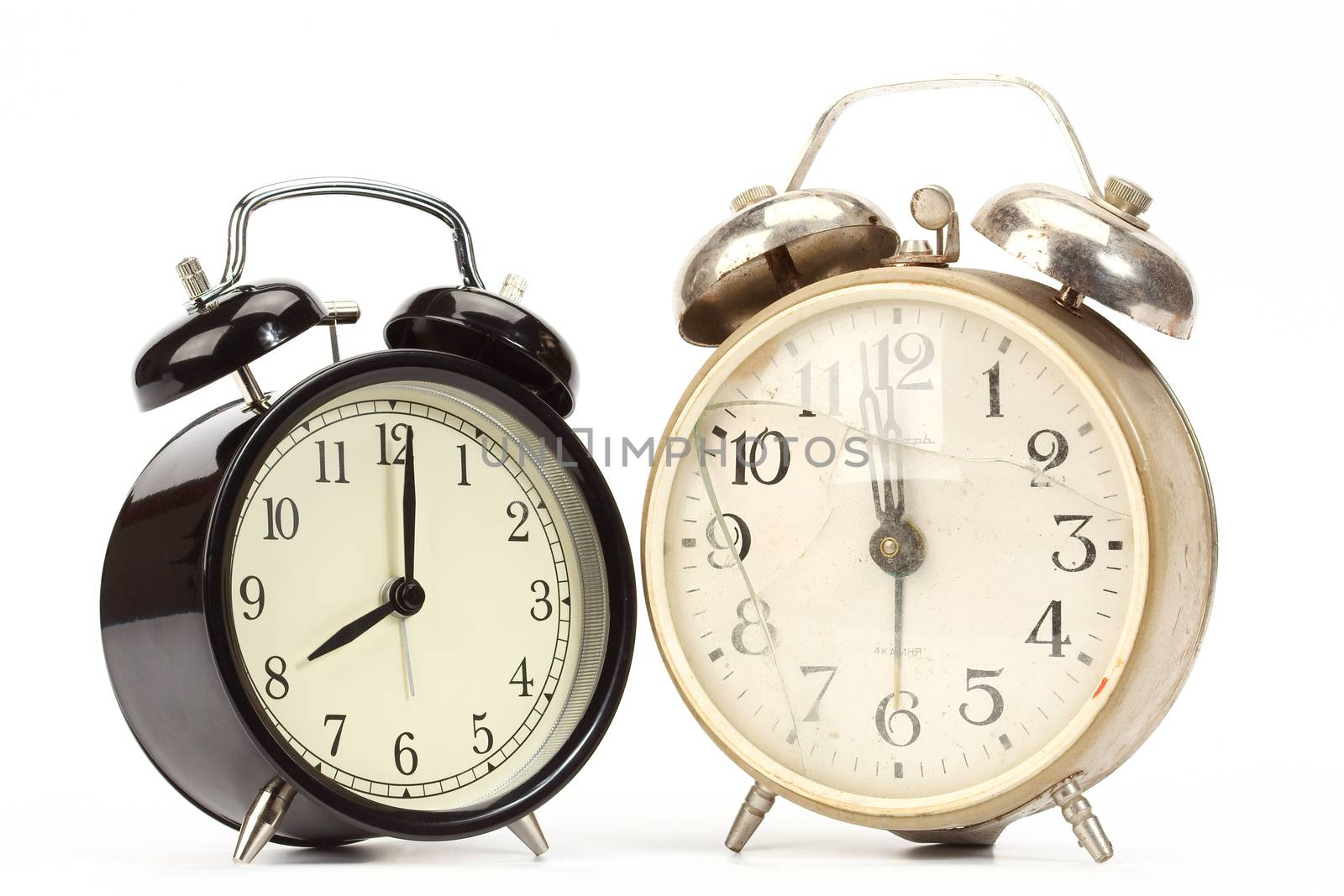 new and old broken alarm clocks over white