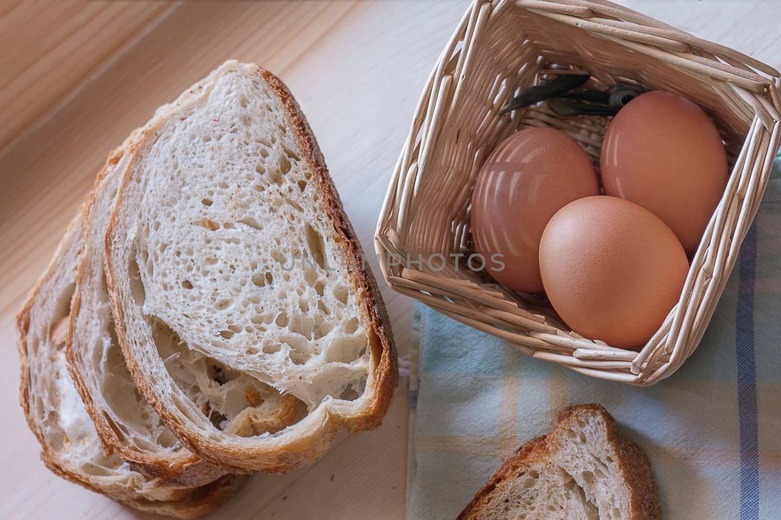 photograph depicting eggs in the basket and sliced bread