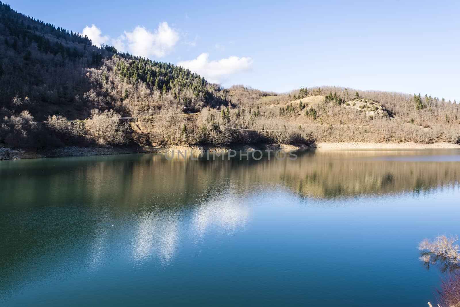 Plastiras lake view with sky reflected in water, in central Greece