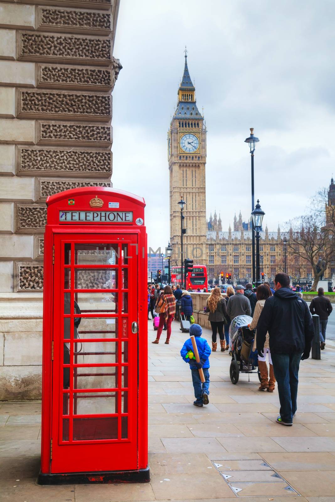 LONDON - APRIL 4: Famous red telephone booth on April 4, 2015 in London, UK. The red telephone box, a telephone kiosk for a public telephone designed by Sir Giles Gilbert Scott.