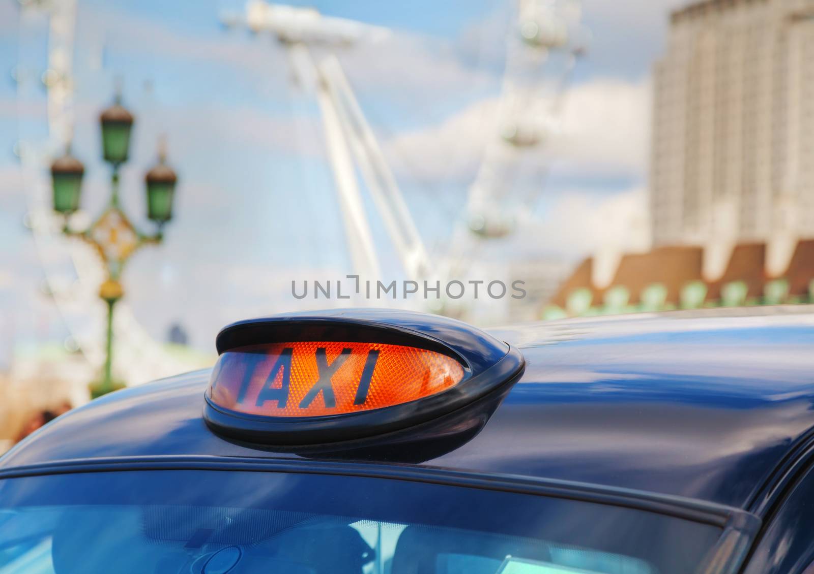 LONDON - APRIL 5: Famous taxi cab (hackney) an a street on April 5, 2015 in London, UK. A hackney or hackney carriage (a cab, black cab, hack or London taxi) is a carriage or automobile for hire.