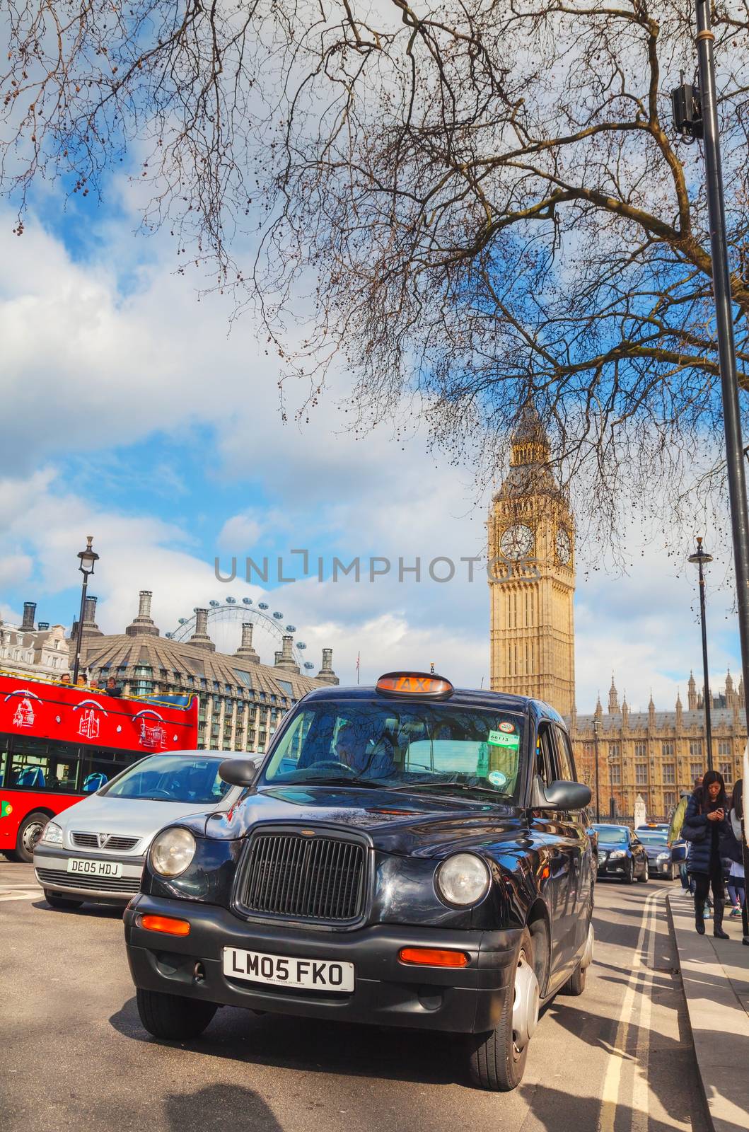LONDON - APRIL 12: Famous taxi cab (hackney) at the Parliament square on April 12, 2015 in London, UK. A hackney or hackney carriage (a cab, black cab, hack or London taxi) is a carriage or automobile for hire.
