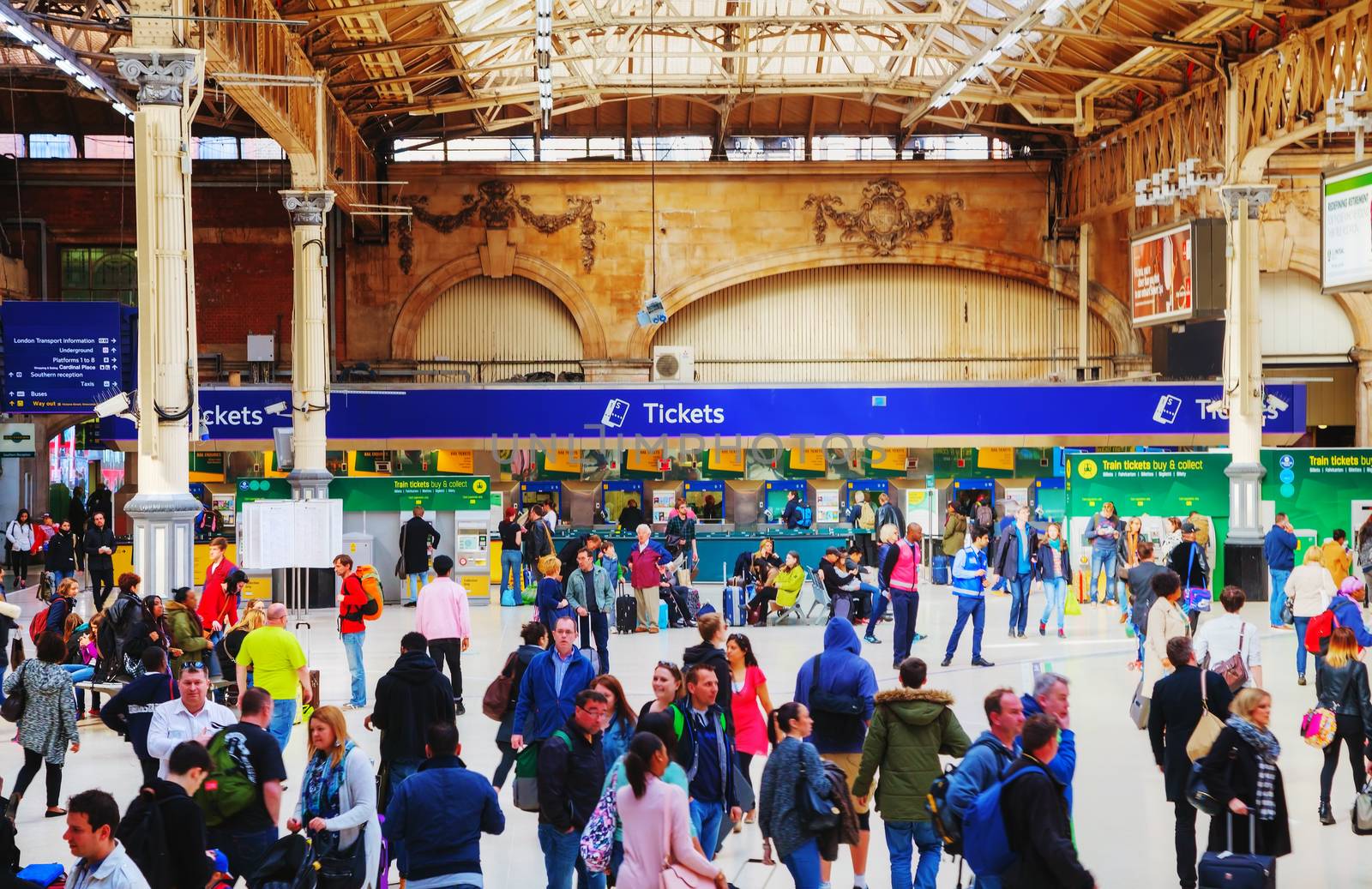 LONDON - APRIL 12: People at the Victoria station on April 12, 2015 in London, UK. Station, generally known as Victoria, is a central London railway terminus and London Underground complex named after Victoria Street.