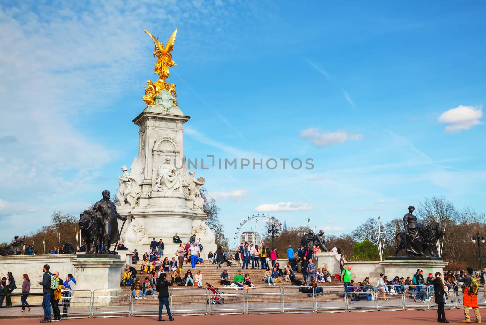 LONDON - APRIL 12: Queen Victoria memorial monument in front of the Buckingham palace on April 12, 2015 in London, UK. It's a monument to Queen Victoria, located at the end of The Mall in London.