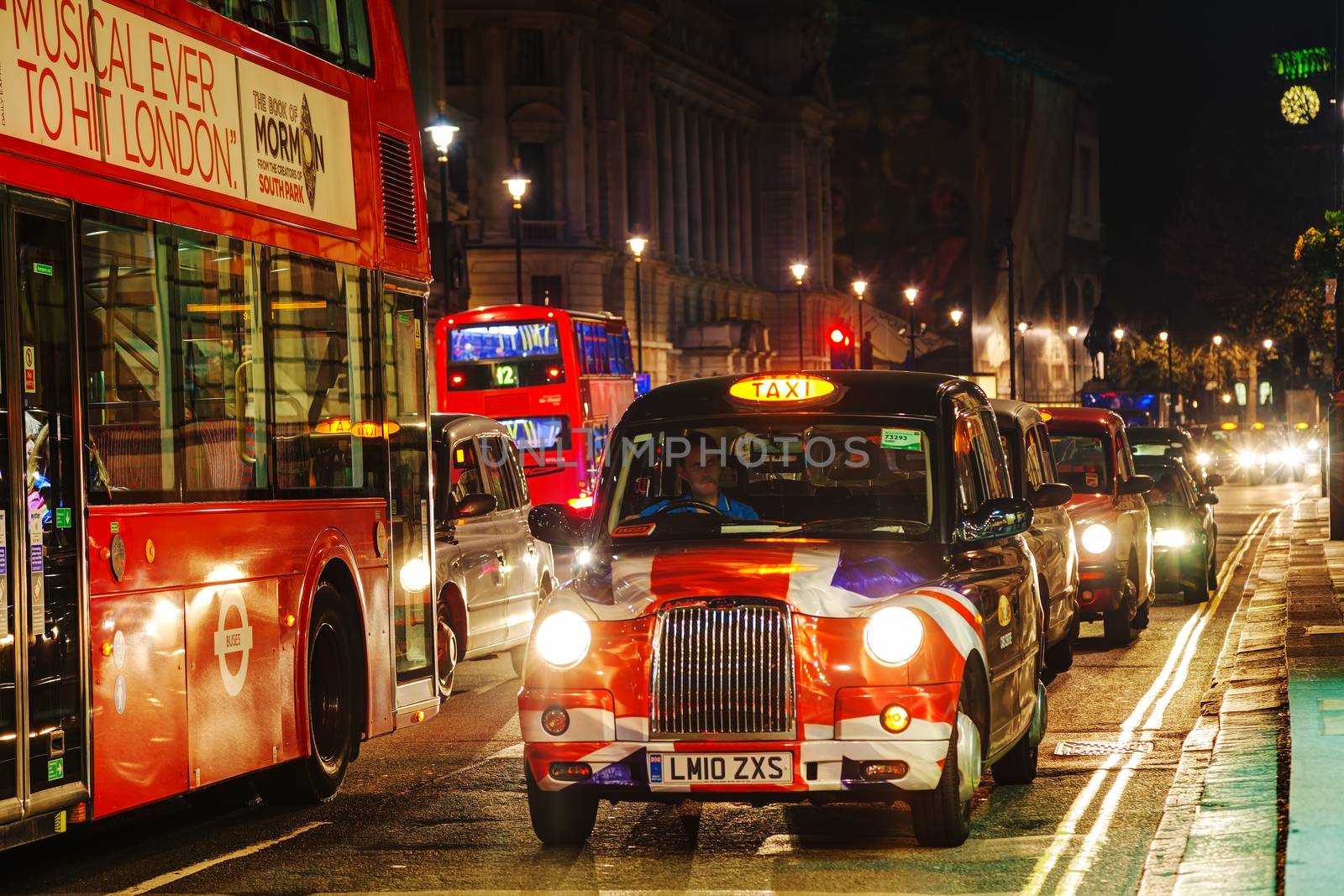 LONDON - APRIL 14: Famous taxi cab (hackney) on a street on April 14, 2015 in London, UK. A hackney or hackney carriage (also called a cab, black cab, hack or London taxi) is a carriage or automobile for hire.