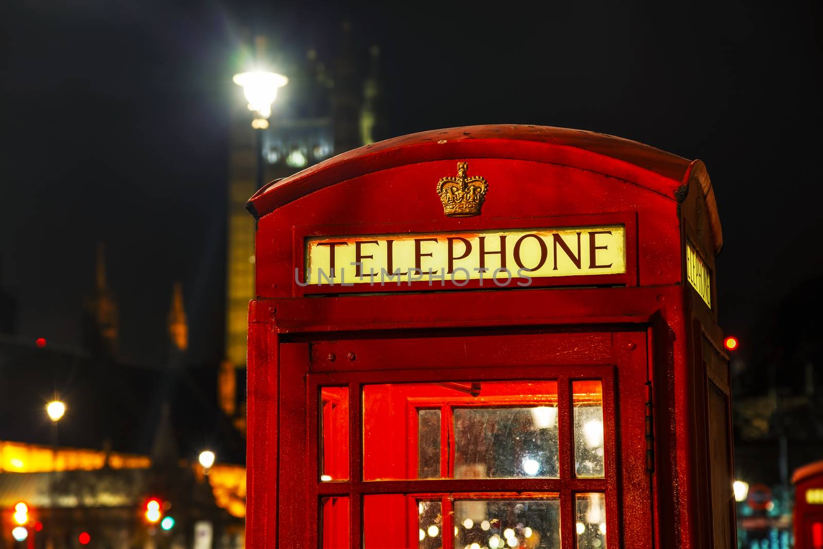 Famous red telephone booth in London, UK at night