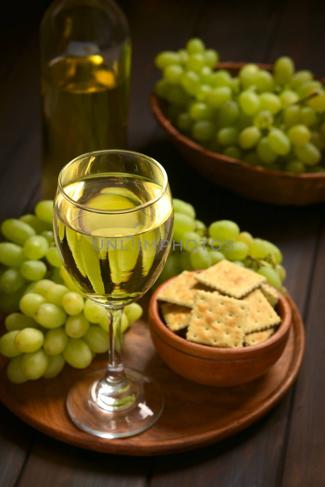 Glass of White Wine and Grapes by ildi