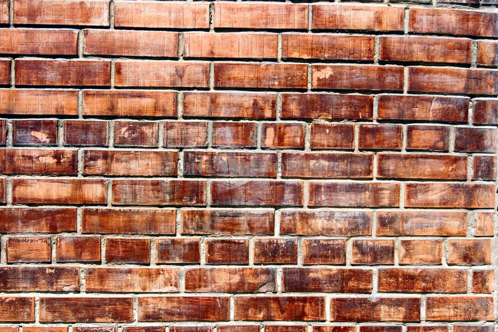 The grunge olden colored brick wall texture