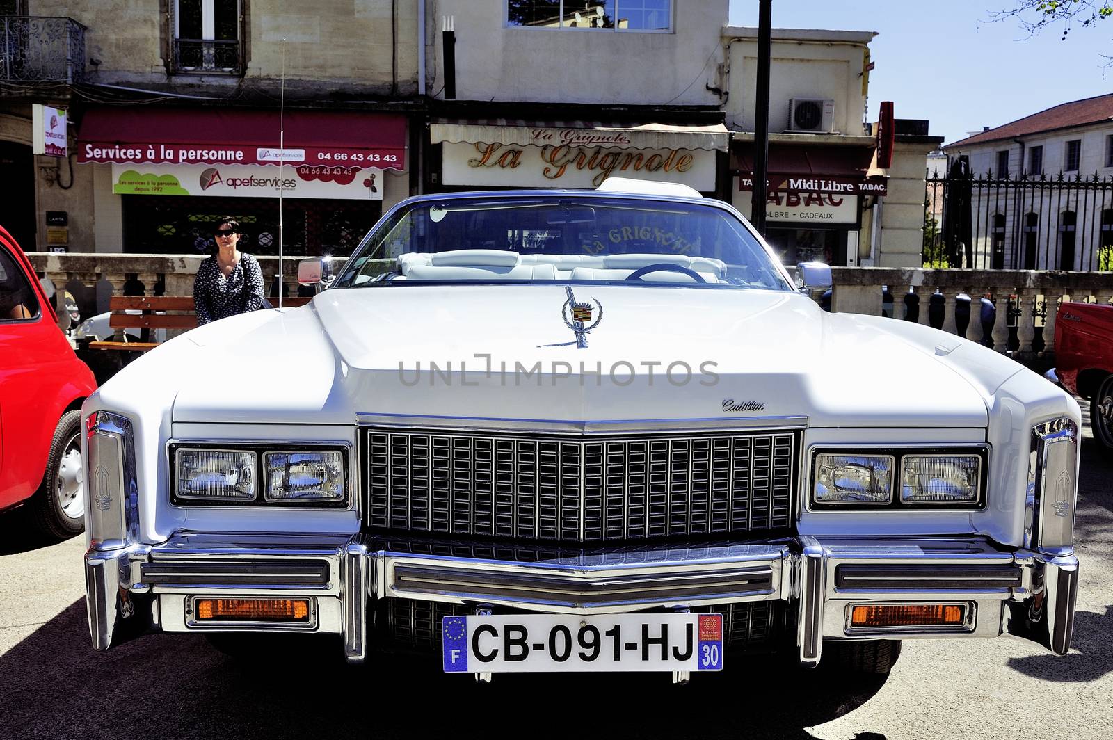 before a white Cadillac Eldorado 1970 photographed at gathering old Town Hall Square cars in the city of Ales in the Gard department